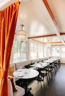 a view of a dining room with furniture and window