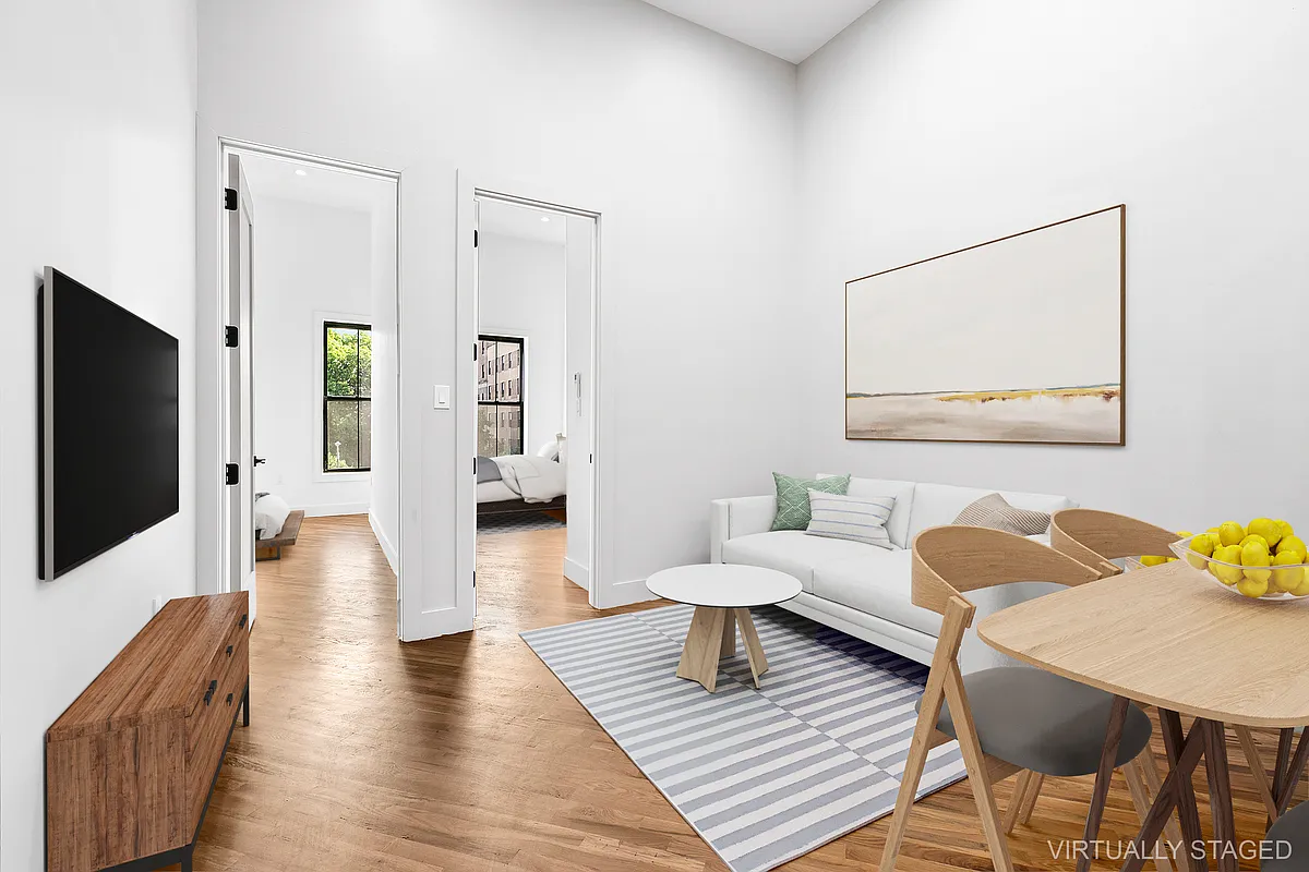 866 Bushwick Avenue, Unit 3 Brooklyn, NY 11221 - Photo 2 of 12 a living room with furniture and a flat screen tv