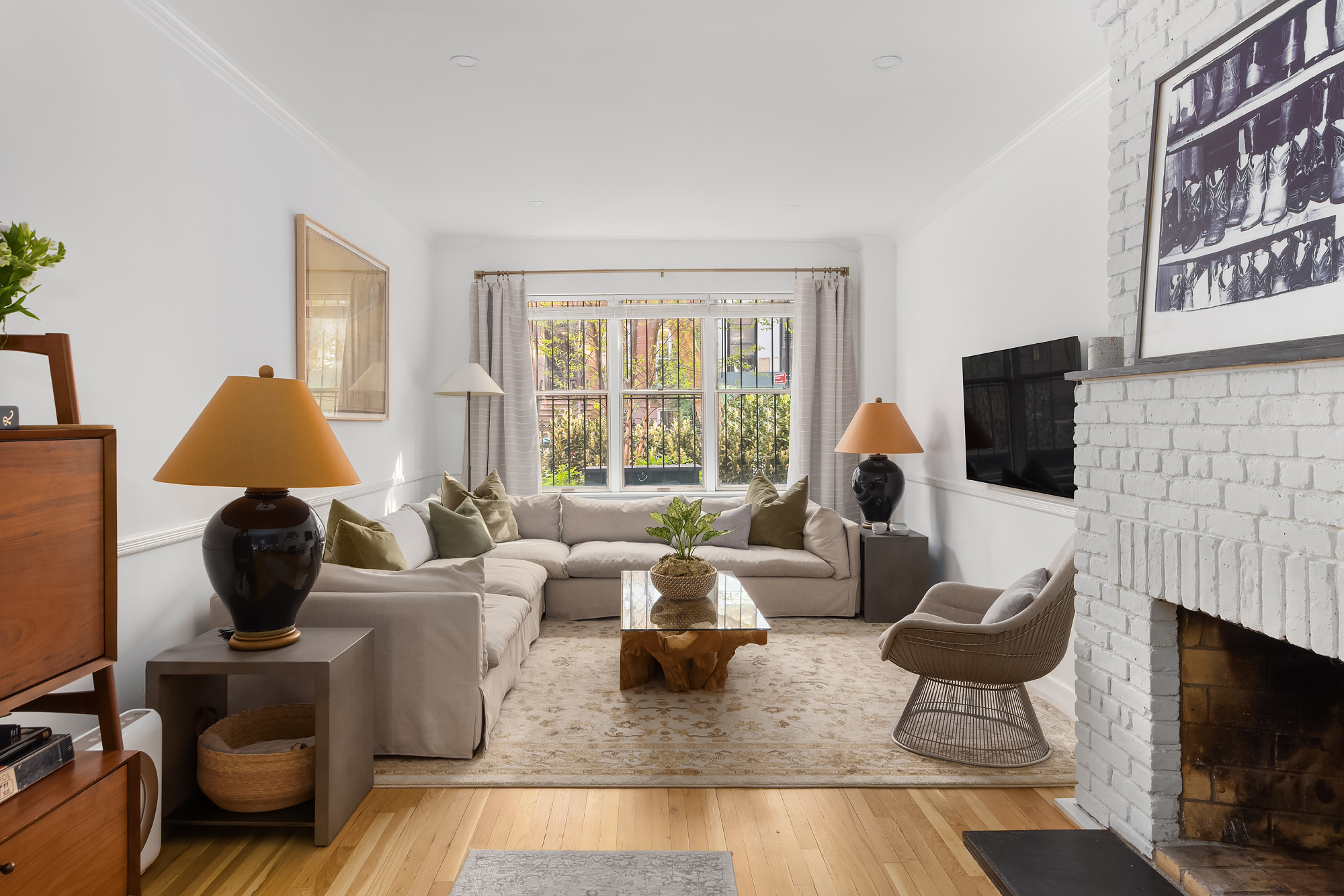 159 West 13th Street Manhattan, NY 10011 - Photo 5 of 36 a living room with furniture a flat screen tv and a fireplace