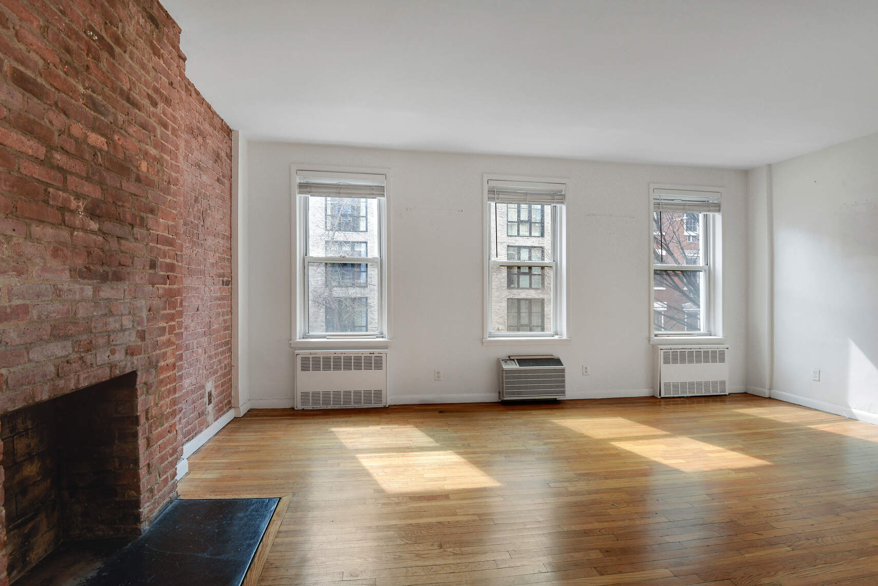 217 West 15th Street Manhattan, NY 10011 - Photo 18 of 21 a view of an empty room with glass door and wooden floor