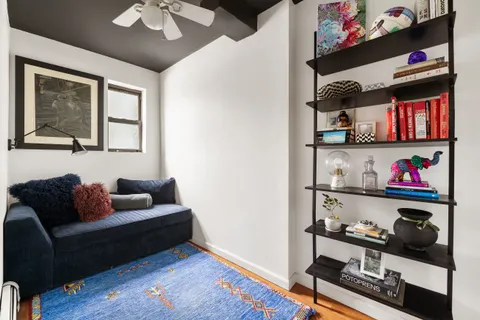 a living room with furniture and book shelf