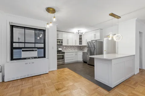 a kitchen with refrigerator and cabinets