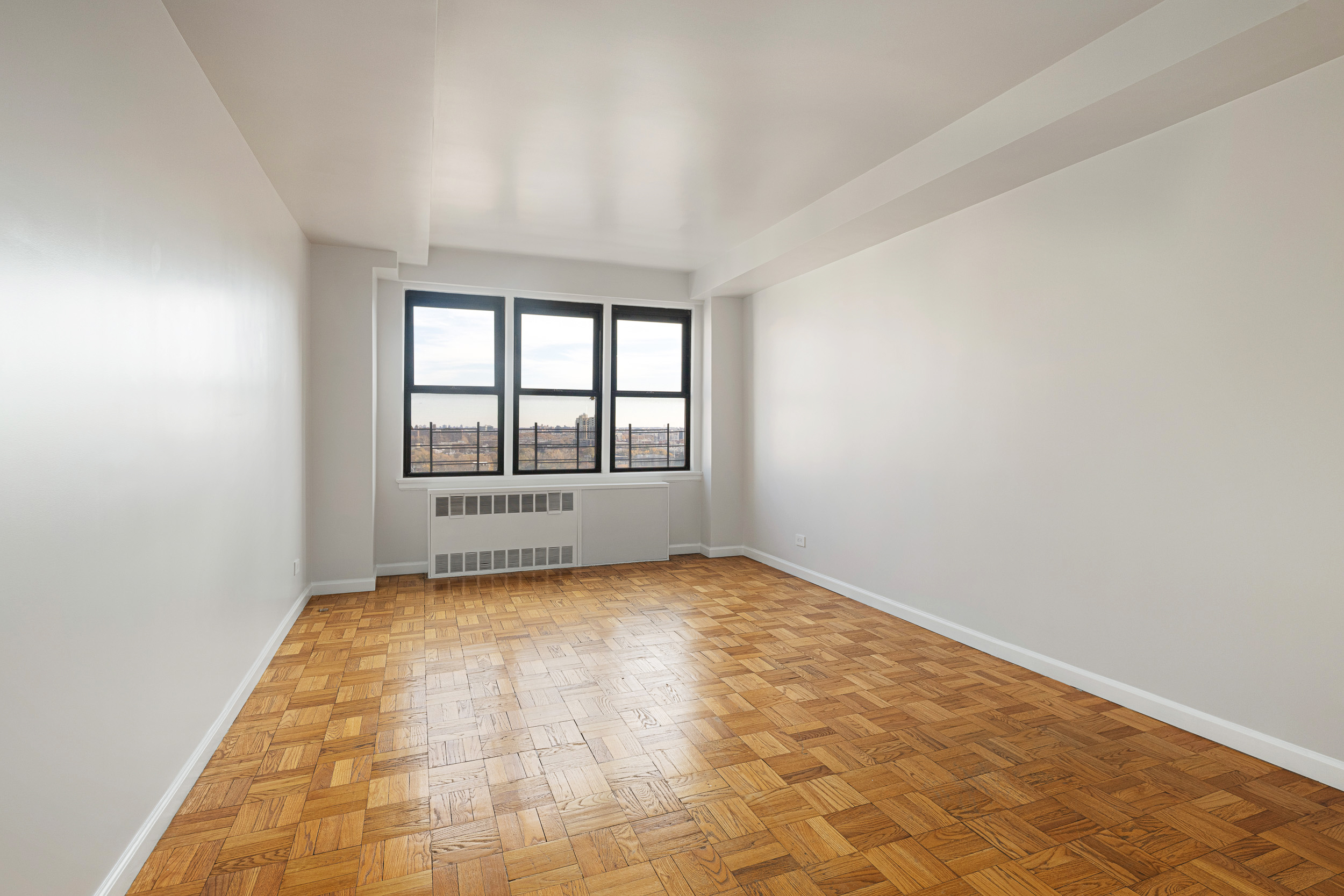 460 East 79th Street, Unit 15F Manhattan, NY 10075 - Photo 3 of 8 an empty room with windows