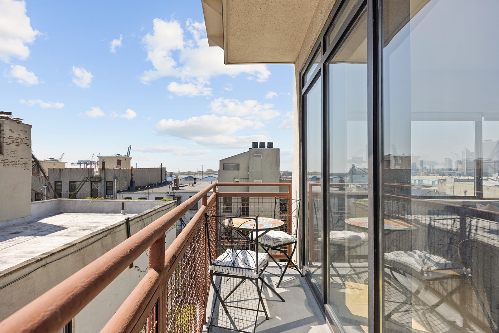 20 Tiffany Place, Unit 5S Brooklyn, NY 11231 - Photo 3 of 12 a city view from a balcony with seating space