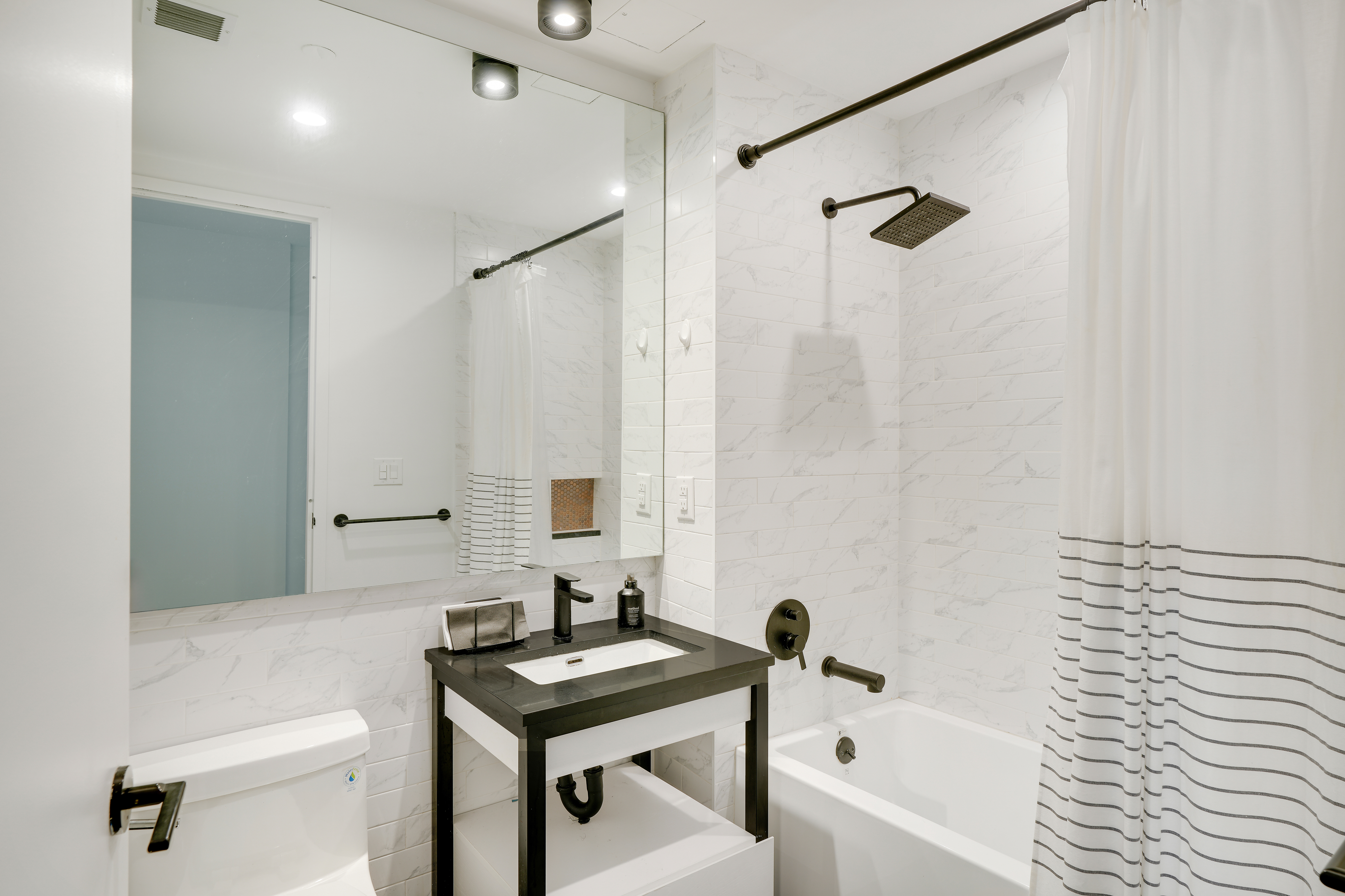 224 West 124th Street, Unit 305 Manhattan, NY 10027 - Photo 9 of 23 a bathroom with a sink toilet and shower