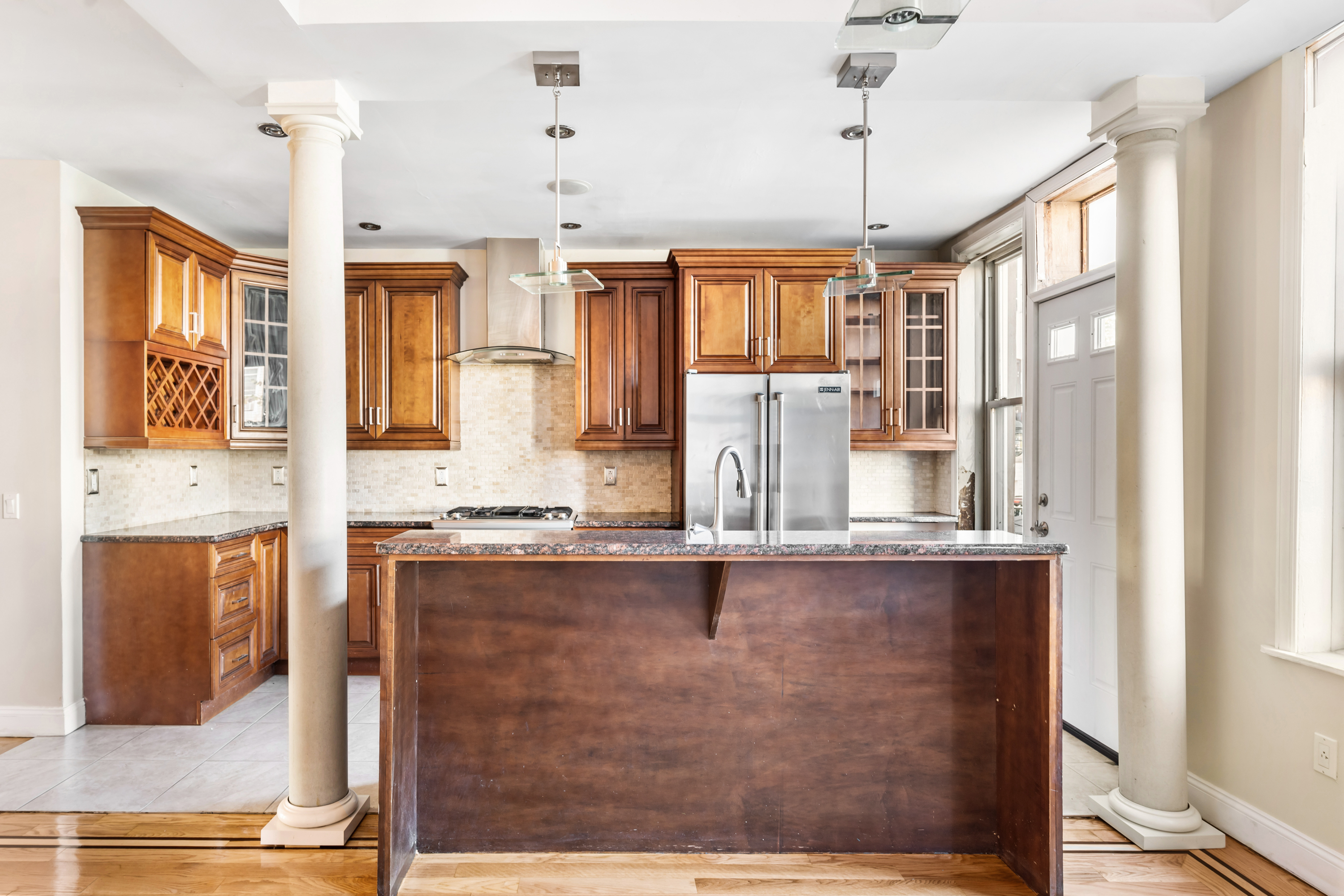 60-13 Menahan Street, Unit 1 Queens, NY 11385 - Photo 6 of 19 a kitchen with stainless steel appliances granite countertop a stove and a sink with wooden floor