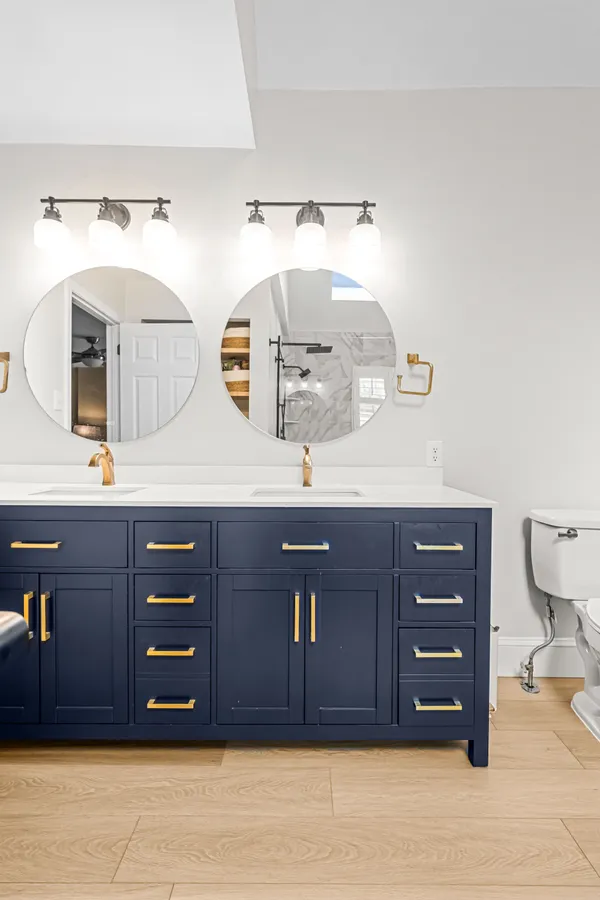 a bathroom with a sink vanity and a mirror