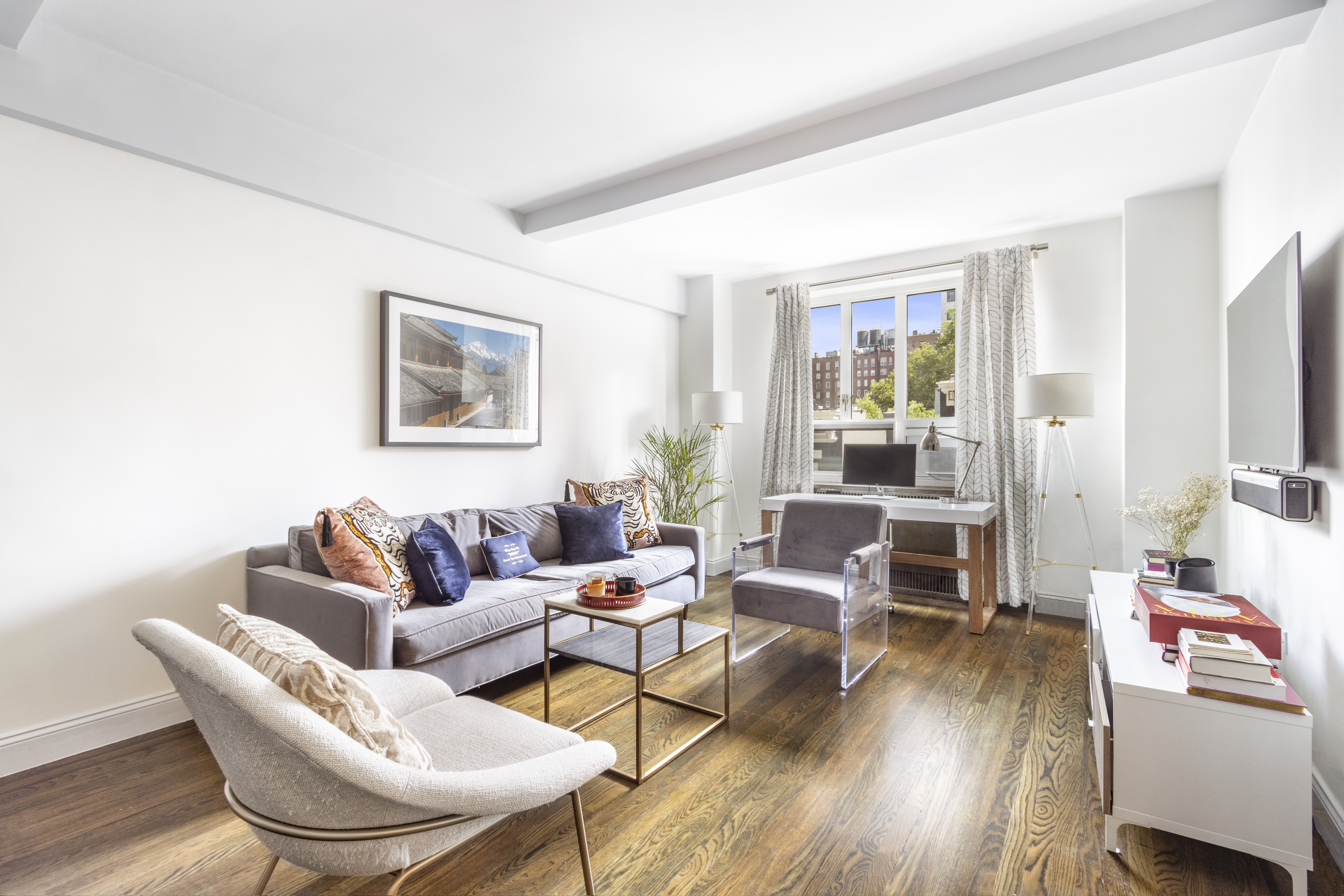 a living room with furniture and wooden floor