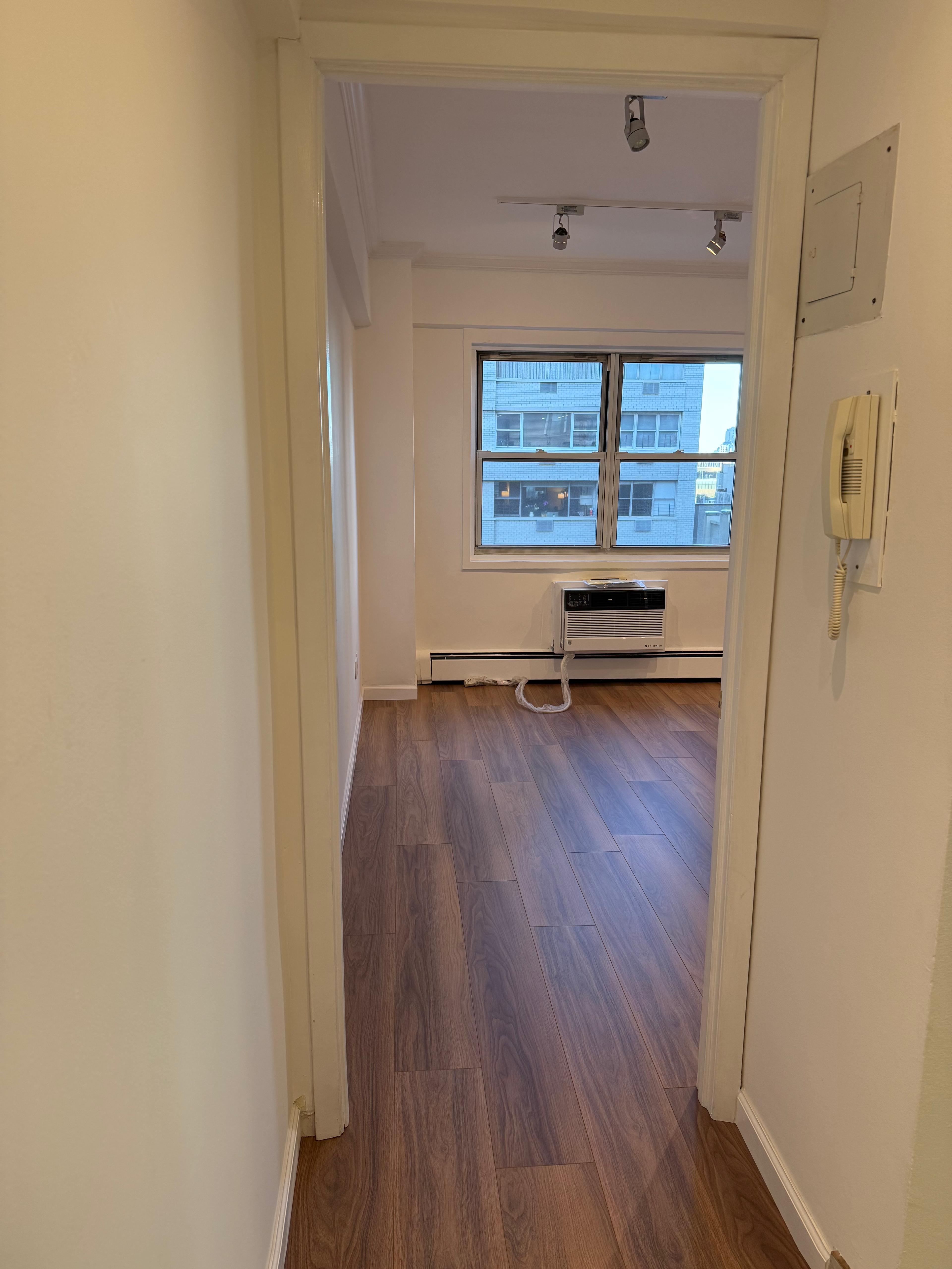 40 Sutton Place, Unit 7A Manhattan, NY 10022 - Photo 6 of 11 a view of a hallway with wooden floor and a window