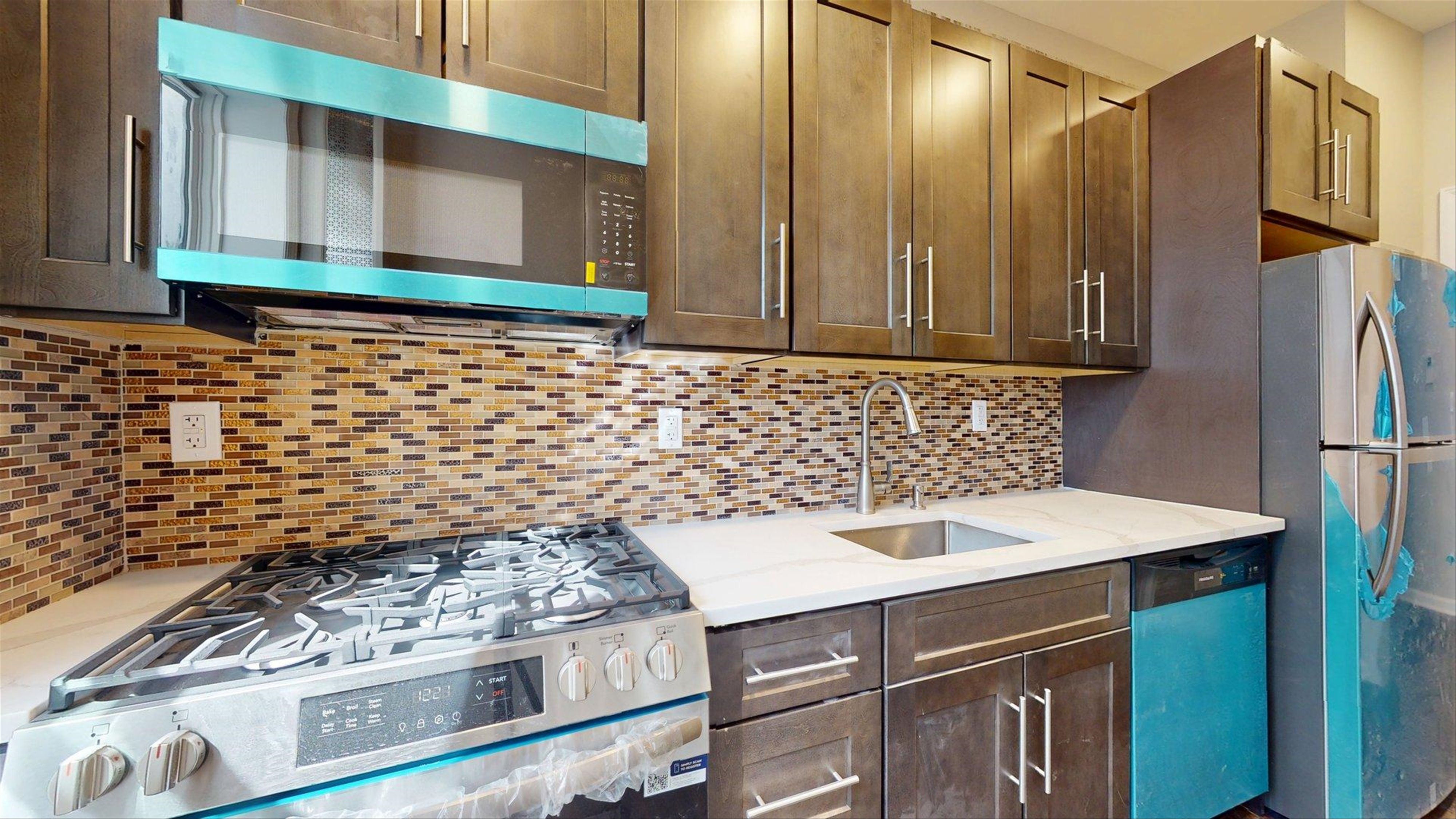 7609 4th Avenue, Unit E14 Brooklyn, NY 11209 - Photo 1 of 15 a kitchen with a sink stove and cabinets
