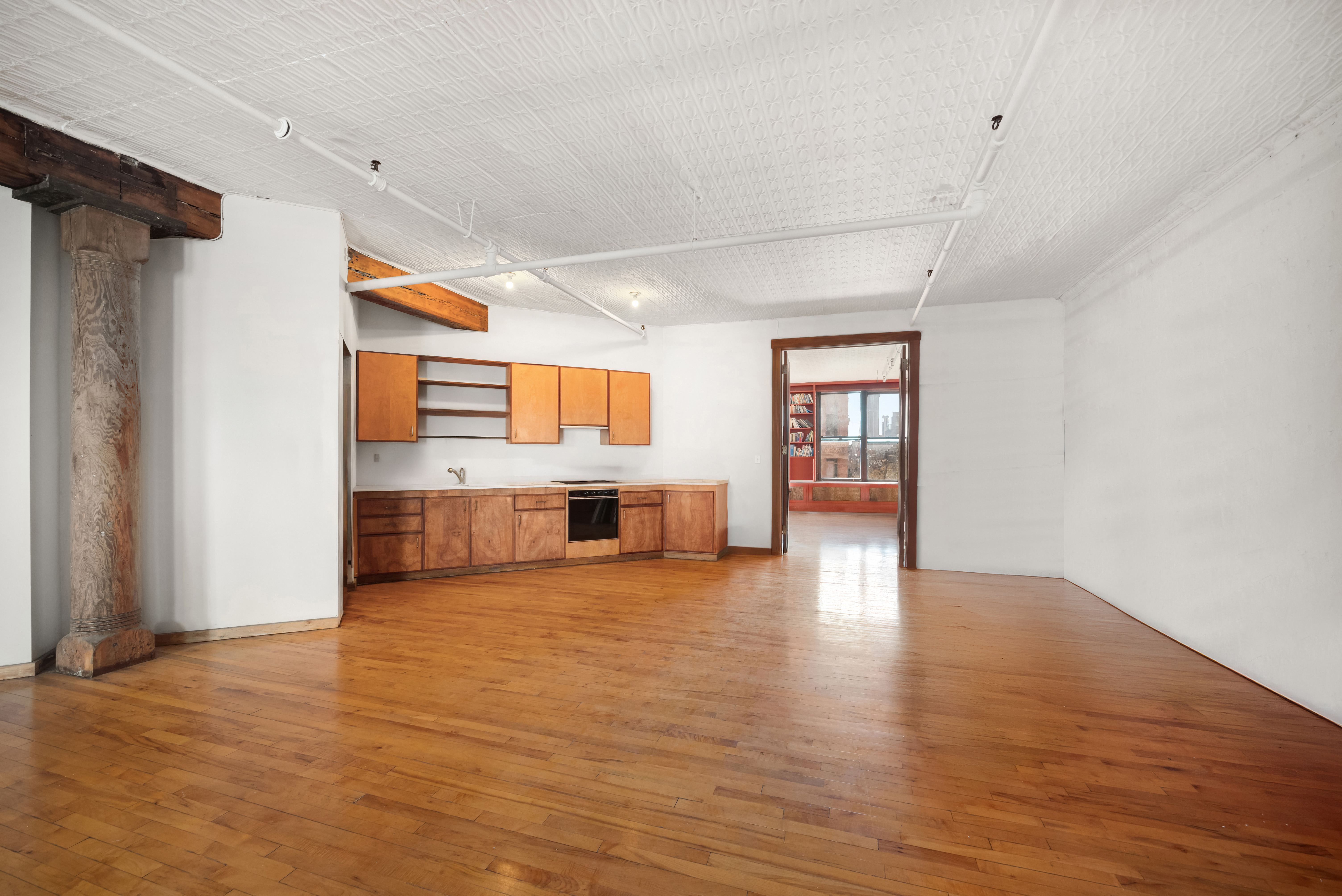 27 Bleecker Street, Unit 6B Manhattan, NY 10012 - Photo 2 of 7 a view of an empty room with window and wooden floor