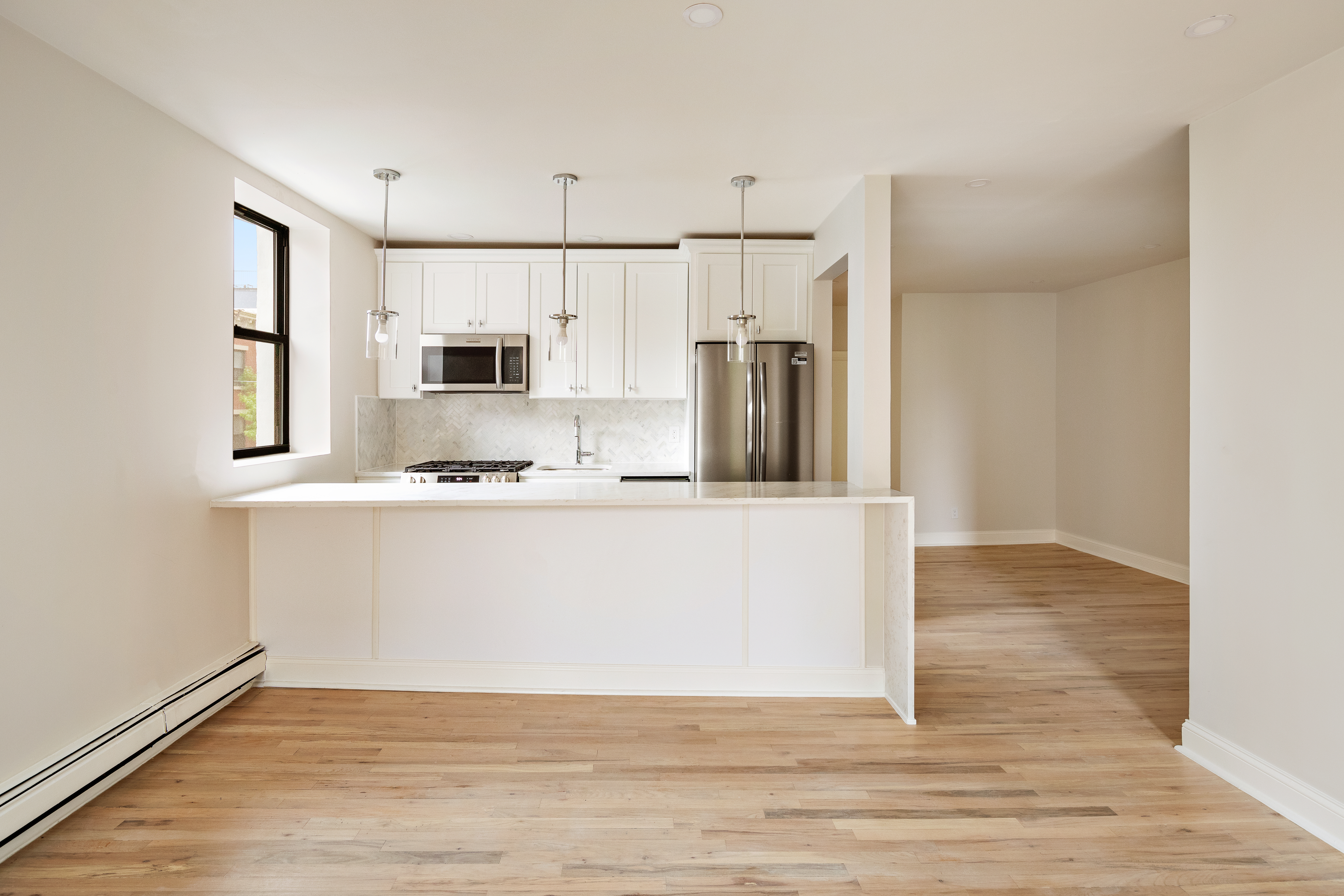 544 Court Street, Unit 2 Brooklyn, NY 11231 - Photo 3 of 9 a view of a kitchen with wooden floor and electronic appliances