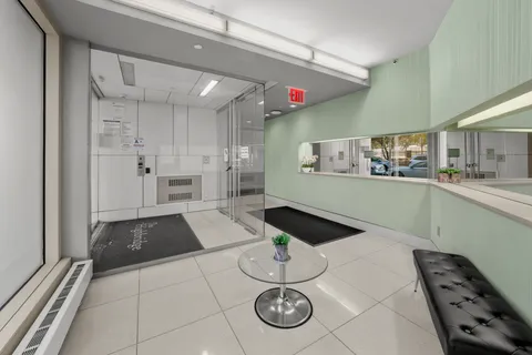 a kitchen with granite countertop a stove a refrigerator and a sink