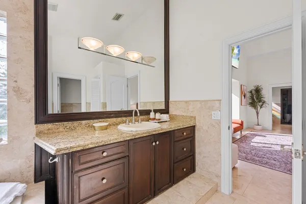 a kitchen with stainless steel appliances granite countertop a stove a sink dishwasher and a refrigerator with wooden cabinets