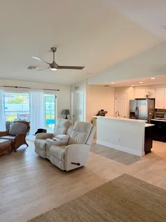 a living room with furniture and kitchen view