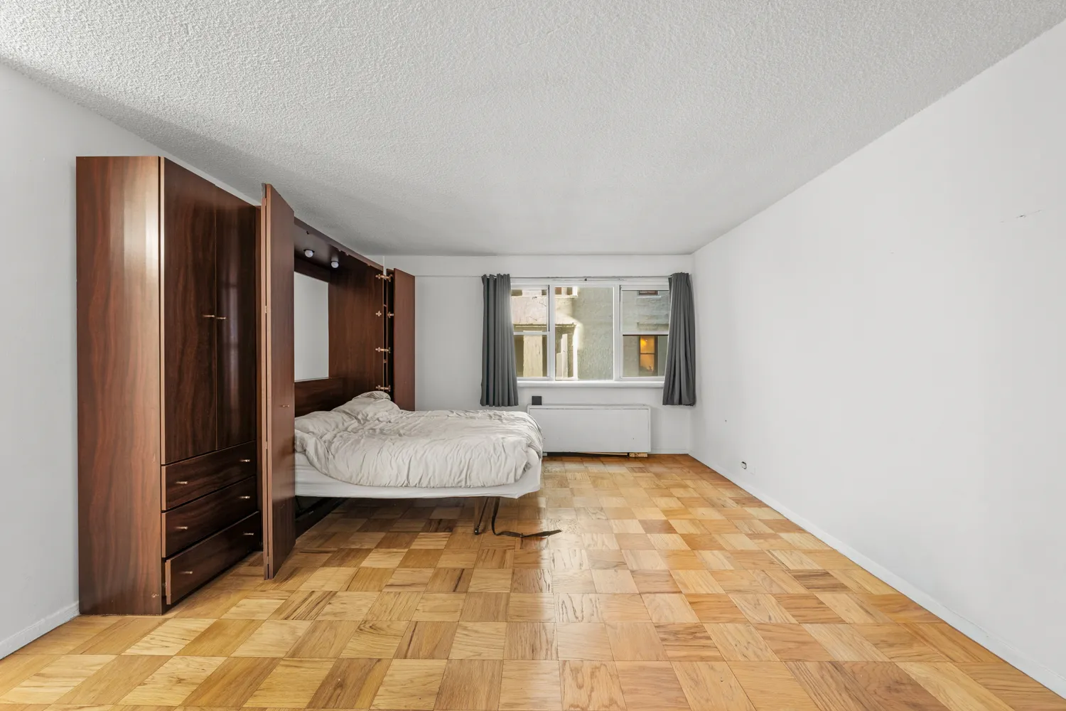 a bedroom with a bed and a window