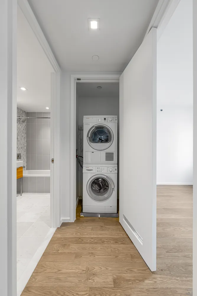 a view of a hallway with washer and dryer