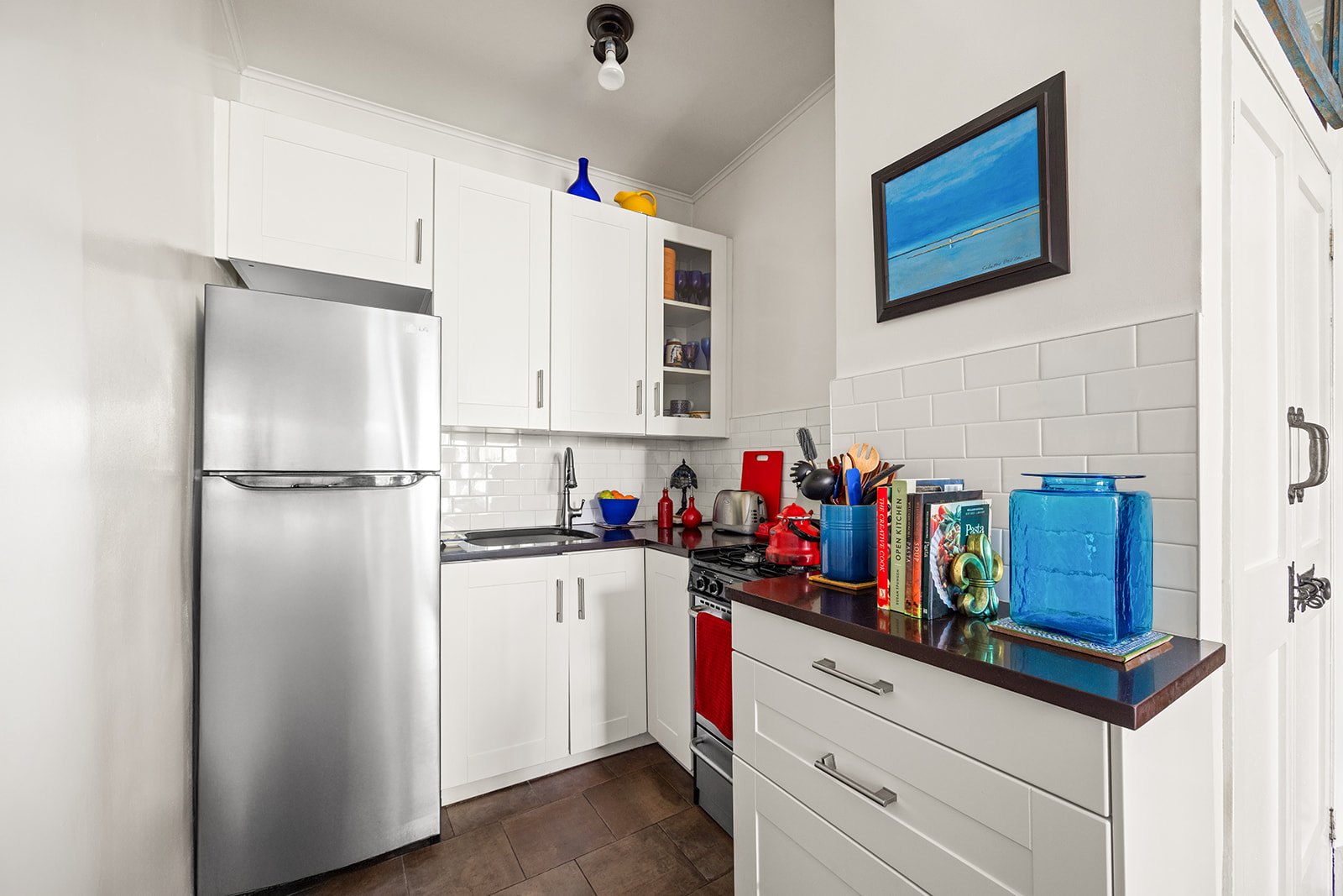 206 Lincoln Place, Unit 7 Brooklyn, NY 11217 - Photo 4 of 9 a kitchen with refrigerator and cabinets