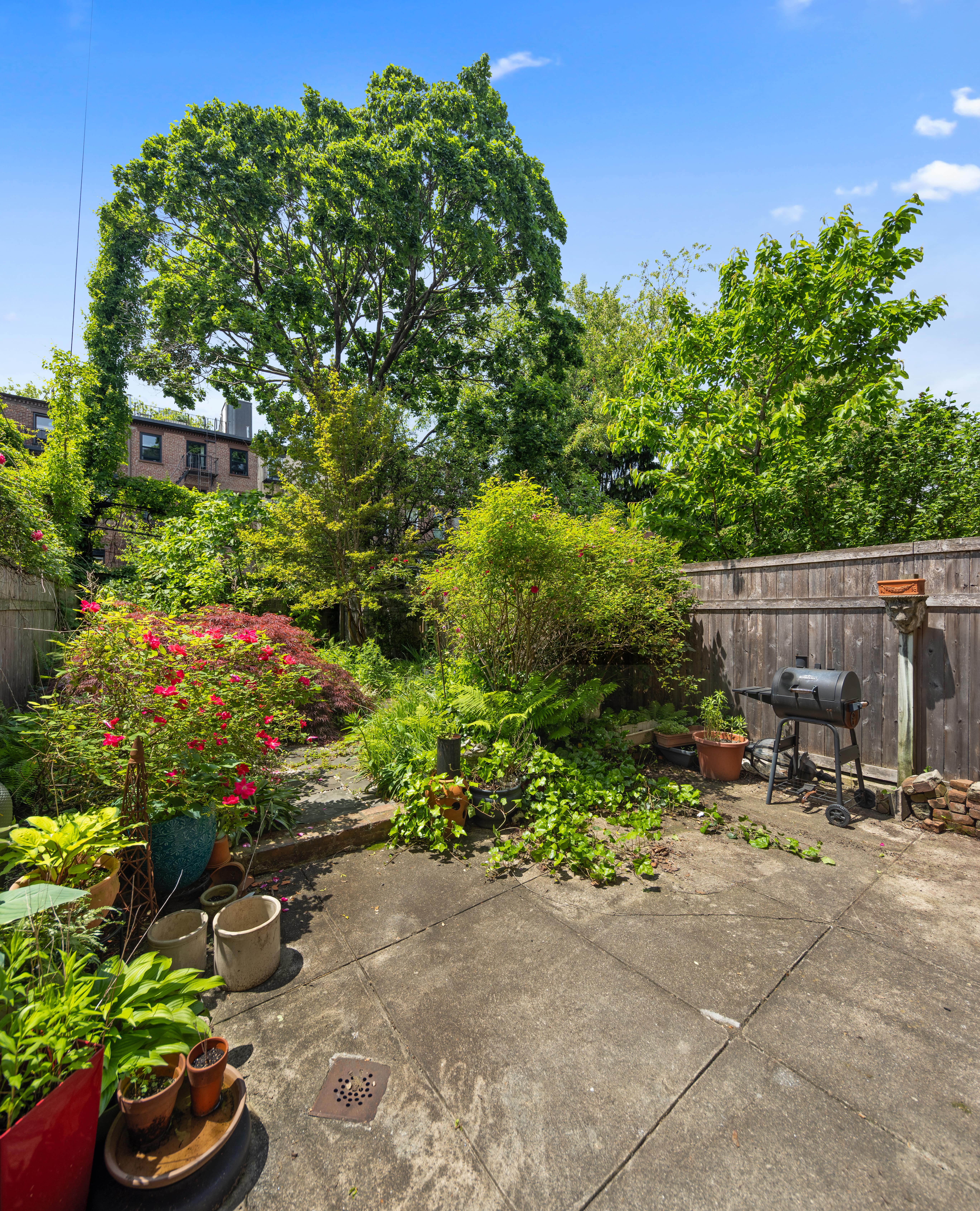 212 Adelphi Street Brooklyn, NY 11205 - Photo 2 of 11 a garden with a bench and some trees