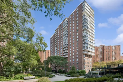 a front view of a multi story building with yard