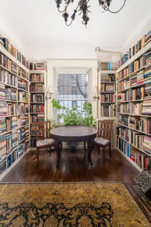 a living room with furniture and a book shelf