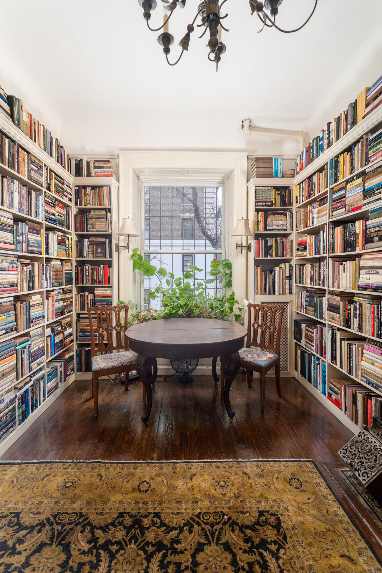 426 West 160th Street Manhattan, NY 10032 - Photo 4 of 33 a living room with furniture and a book shelf