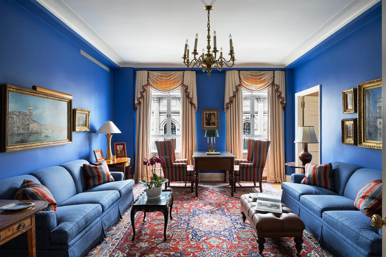a living room with furniture a chandelier and a chandelier