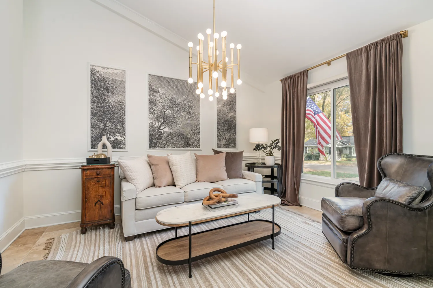 a living room with furniture and a chandelier