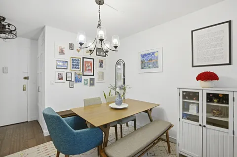 a view of a dining room with furniture and chandelier