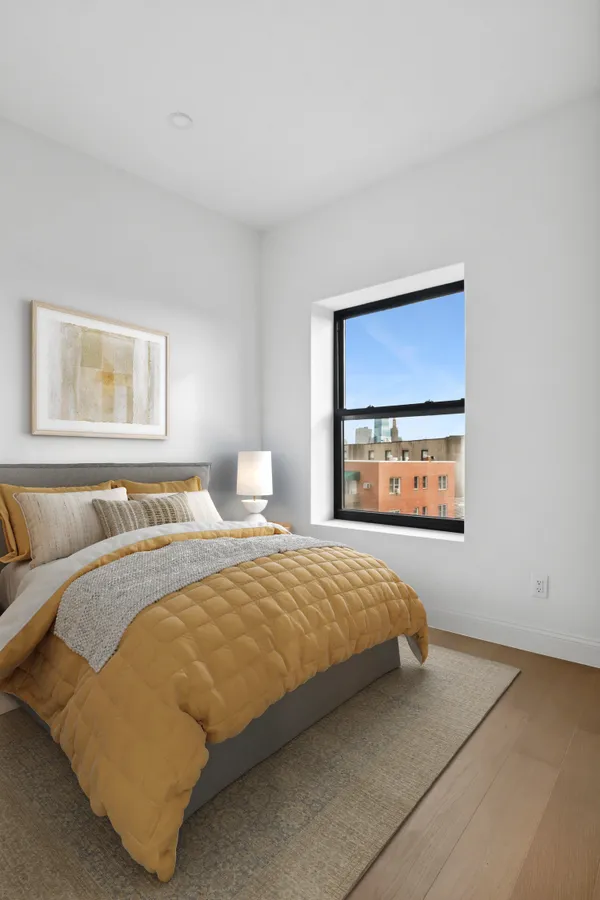 a bedroom with a bed and window