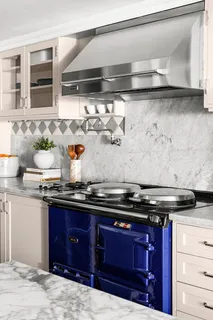 a kitchen with granite countertop a stove and cabinets