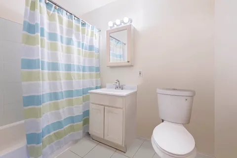 a white toilet sitting next to a bathroom sink