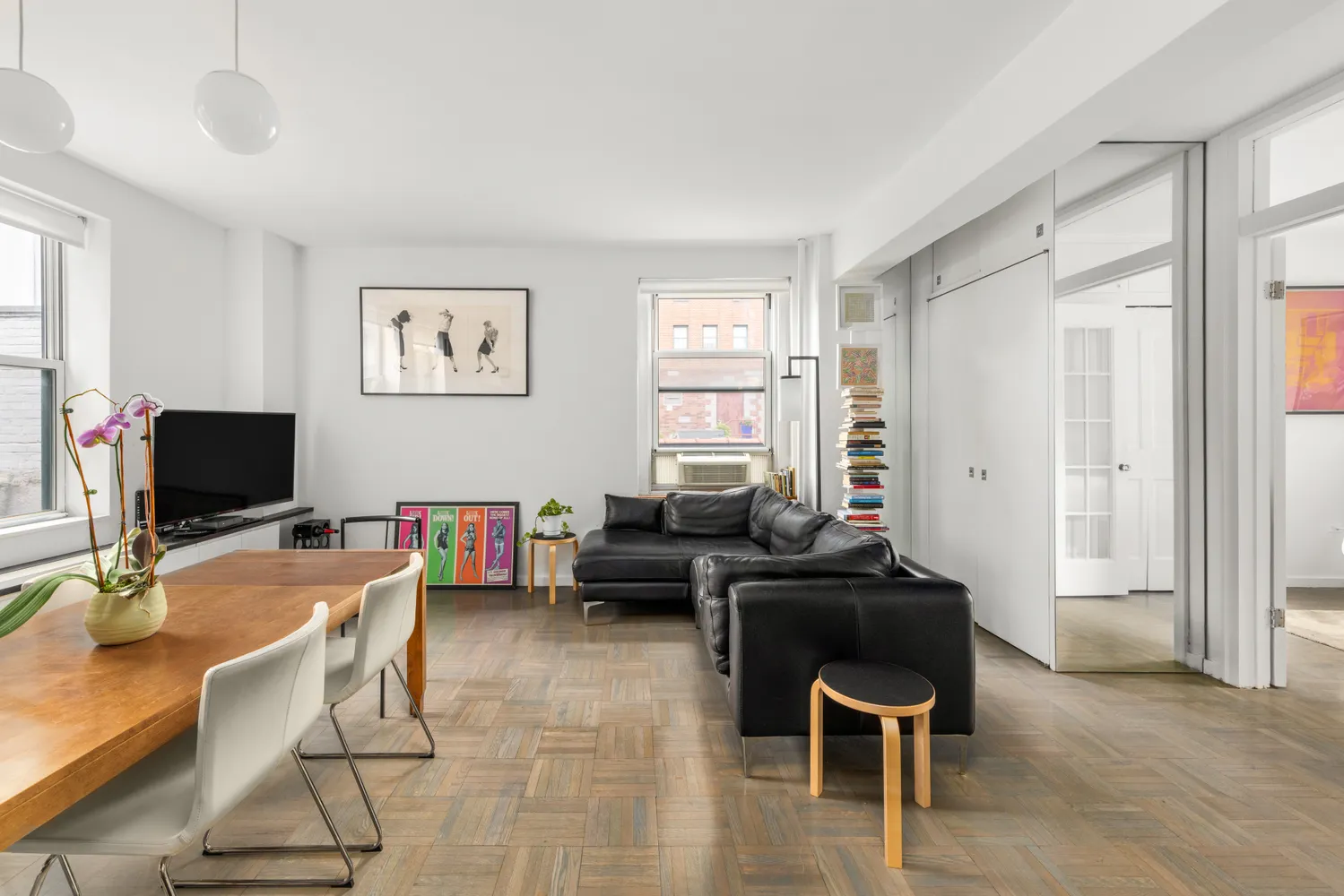 a livingroom with workspace and a window