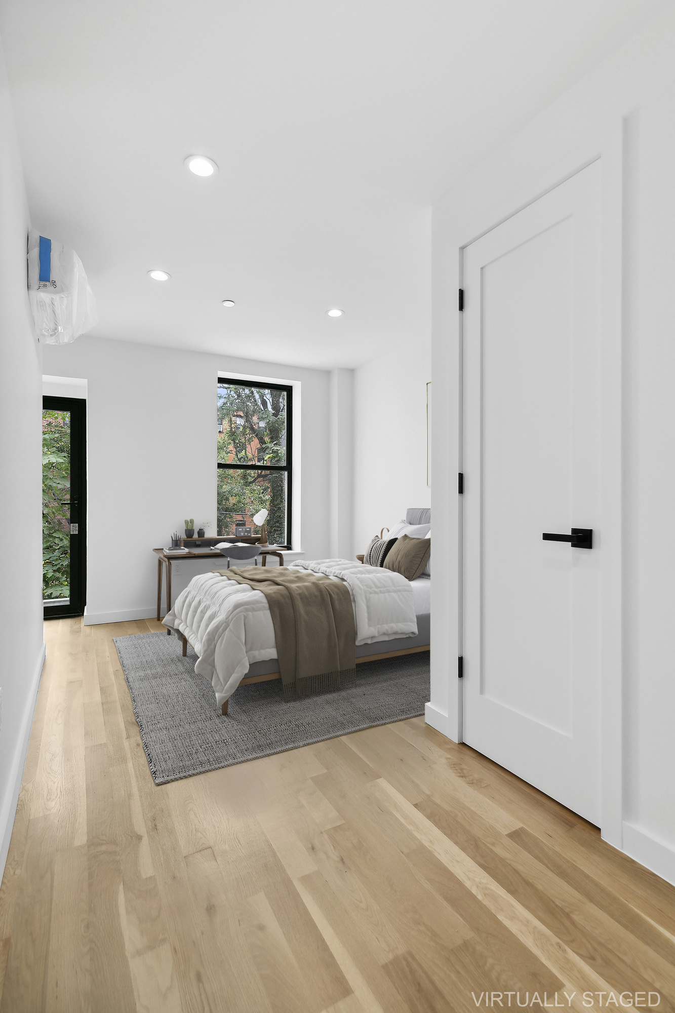 116 Madison Street Brooklyn, NY 11216 - Photo 17 of 20 a bedroom with a large bed and a chandelier