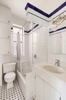 a bathroom with a sink toilet a mirror a bathtub and shower