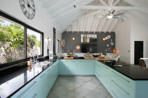 a large kitchen with a large window and stainless steel appliances