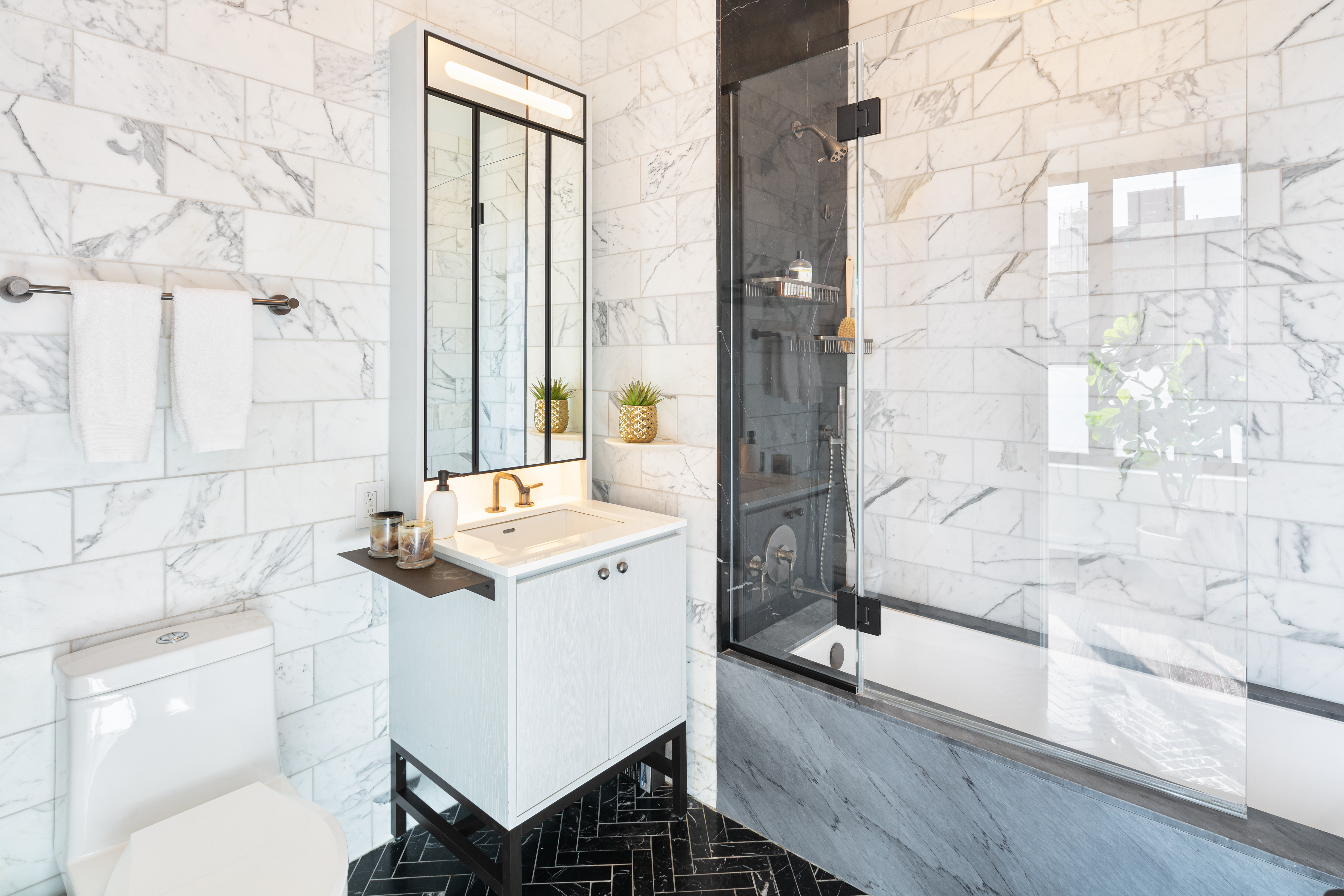 959 1st Avenue, Unit 22E Manhattan, NY 10022 - Photo 5 of 8 a bathroom with a sink toilet a mirror and shower