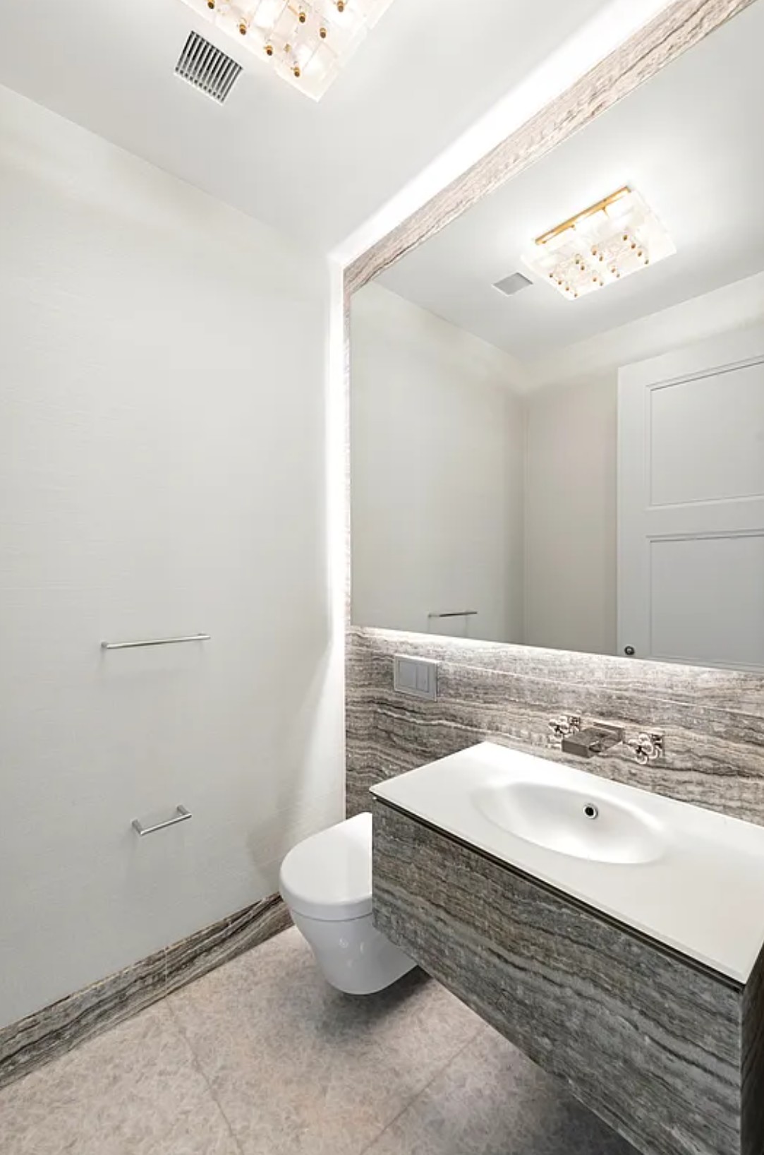 35 Hudson Yards, Unit 6701 Manhattan, NY 10001 - Photo 13 of 23 a bathroom with a sink a toilet and mirror