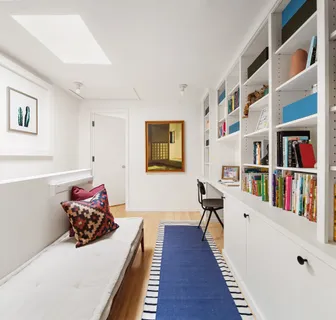 a hallway with furniture and a book shelf