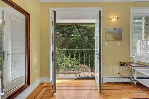 a bathroom with a tub a sink and large window