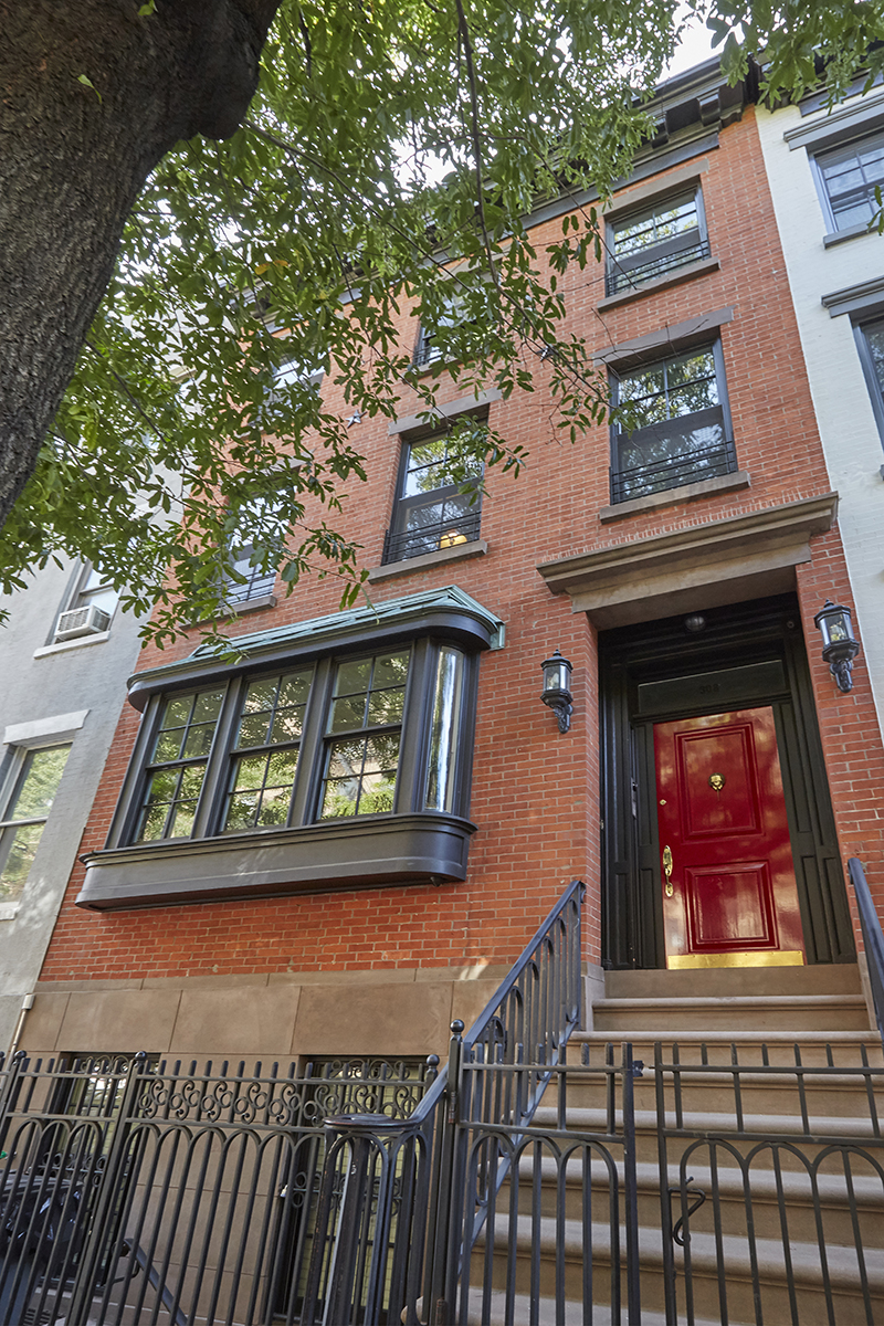 a front view of a house with large windows
