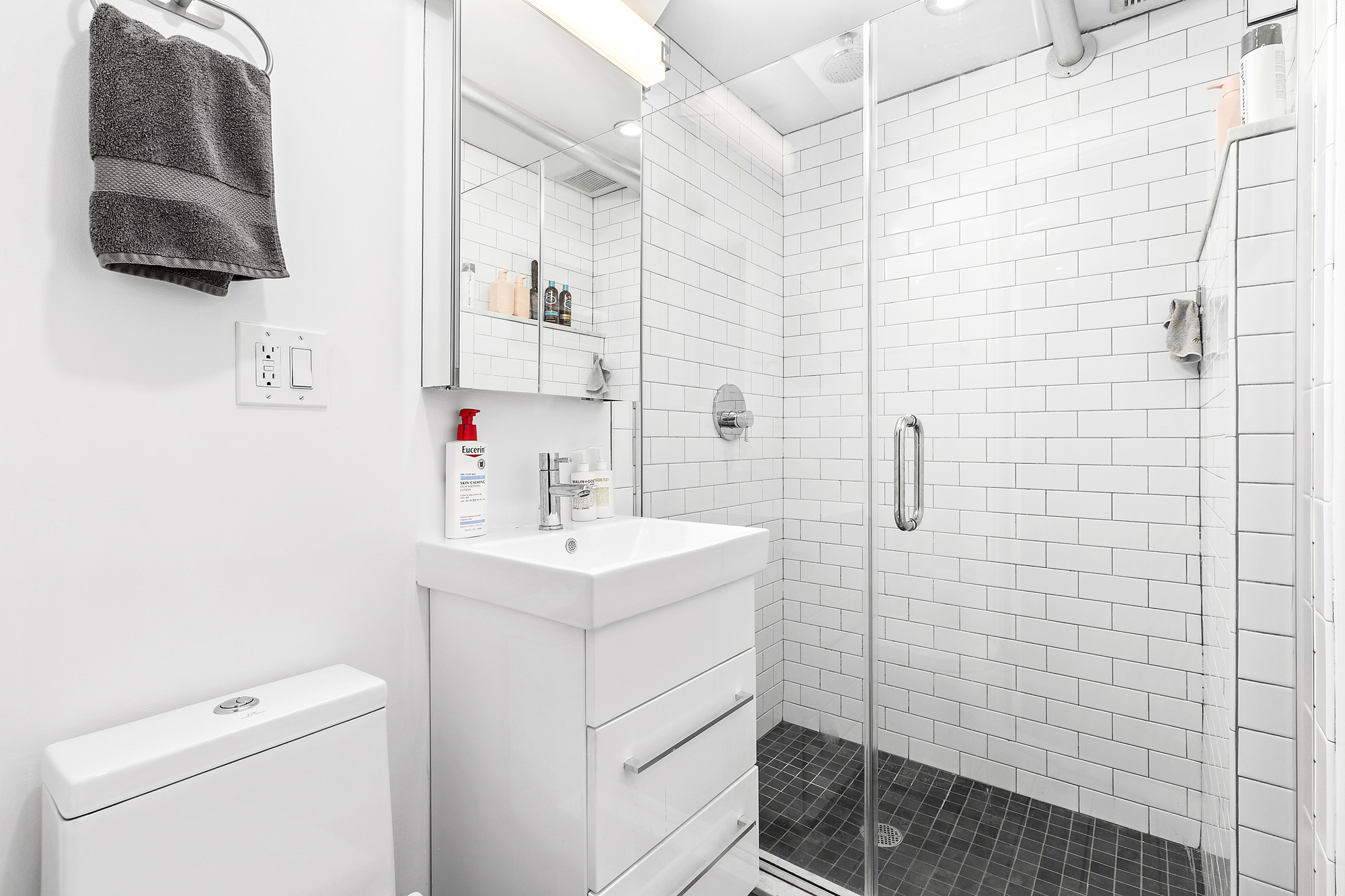 140 West 10th Street, Unit BTW Manhattan, NY 10014 - Photo 5 of 8 a bathroom with a sink a toilet and shower