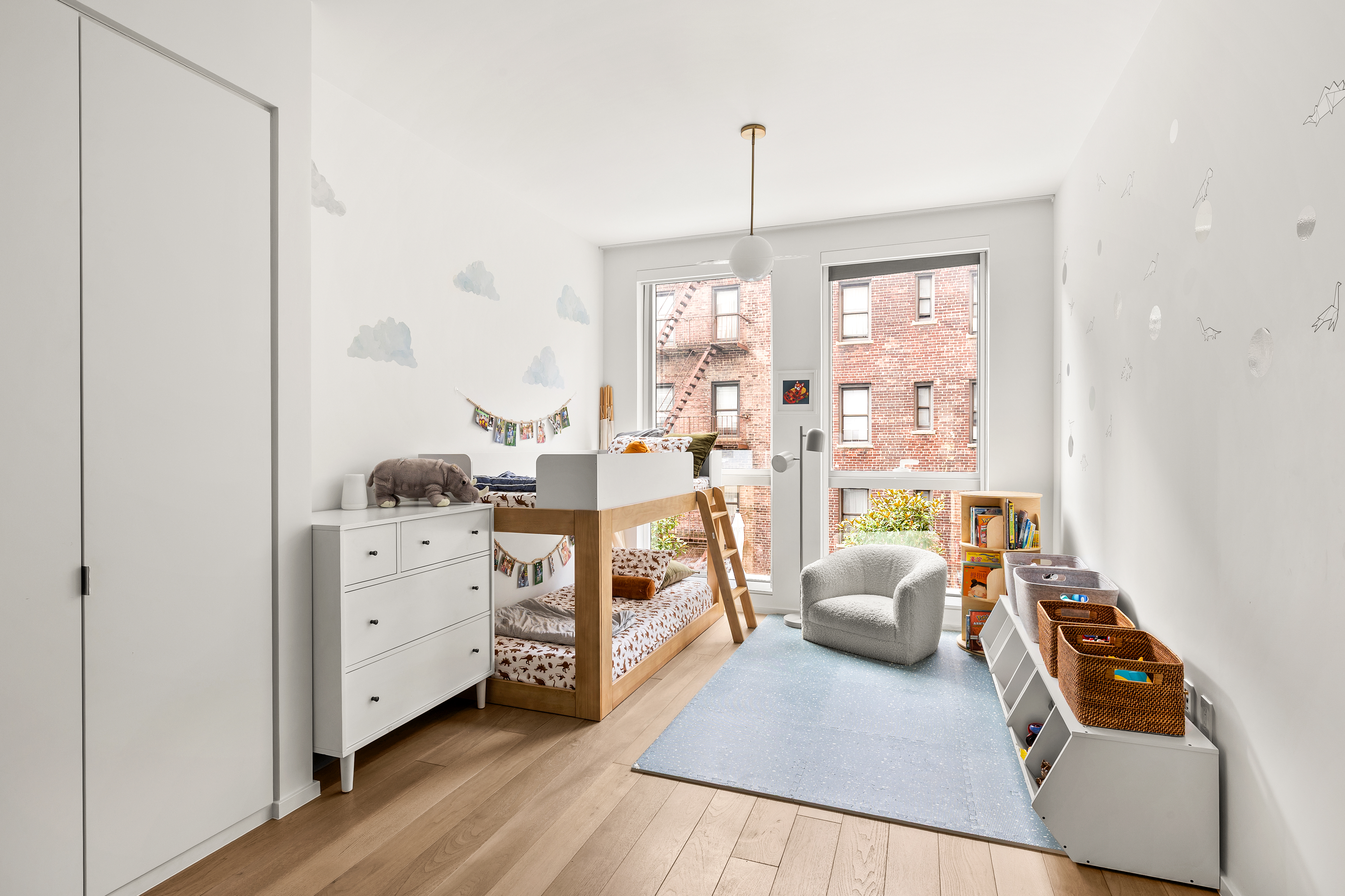 150 East 23rd Street, Unit 3C Manhattan, NY 10010 - Photo 6 of 12 a bedroom with furniture and a wooden floor