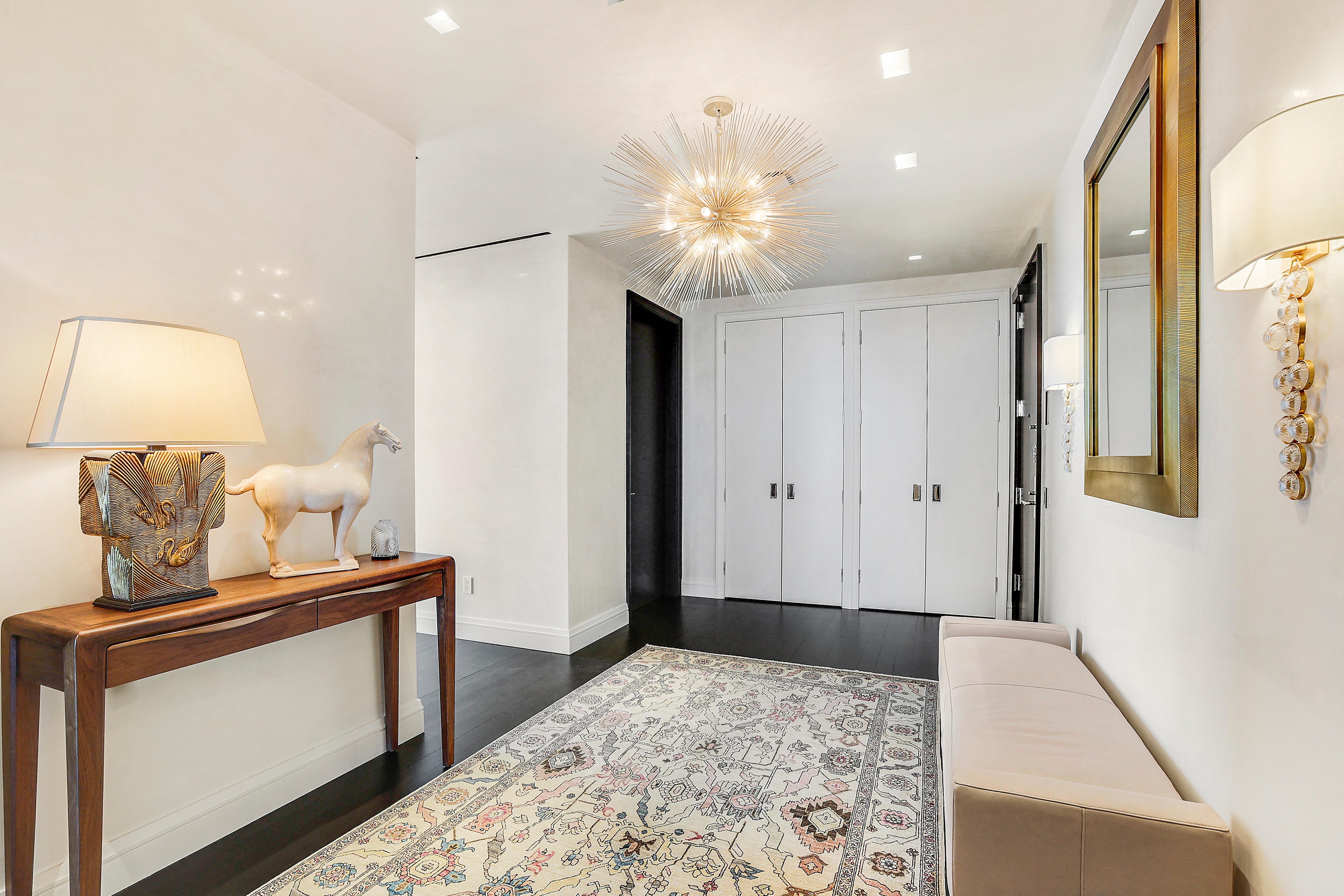 157 West 57th Street, Unit 51A Manhattan, NY 10019 - Photo 3 of 15 a bedroom with a bed and a dresser in it