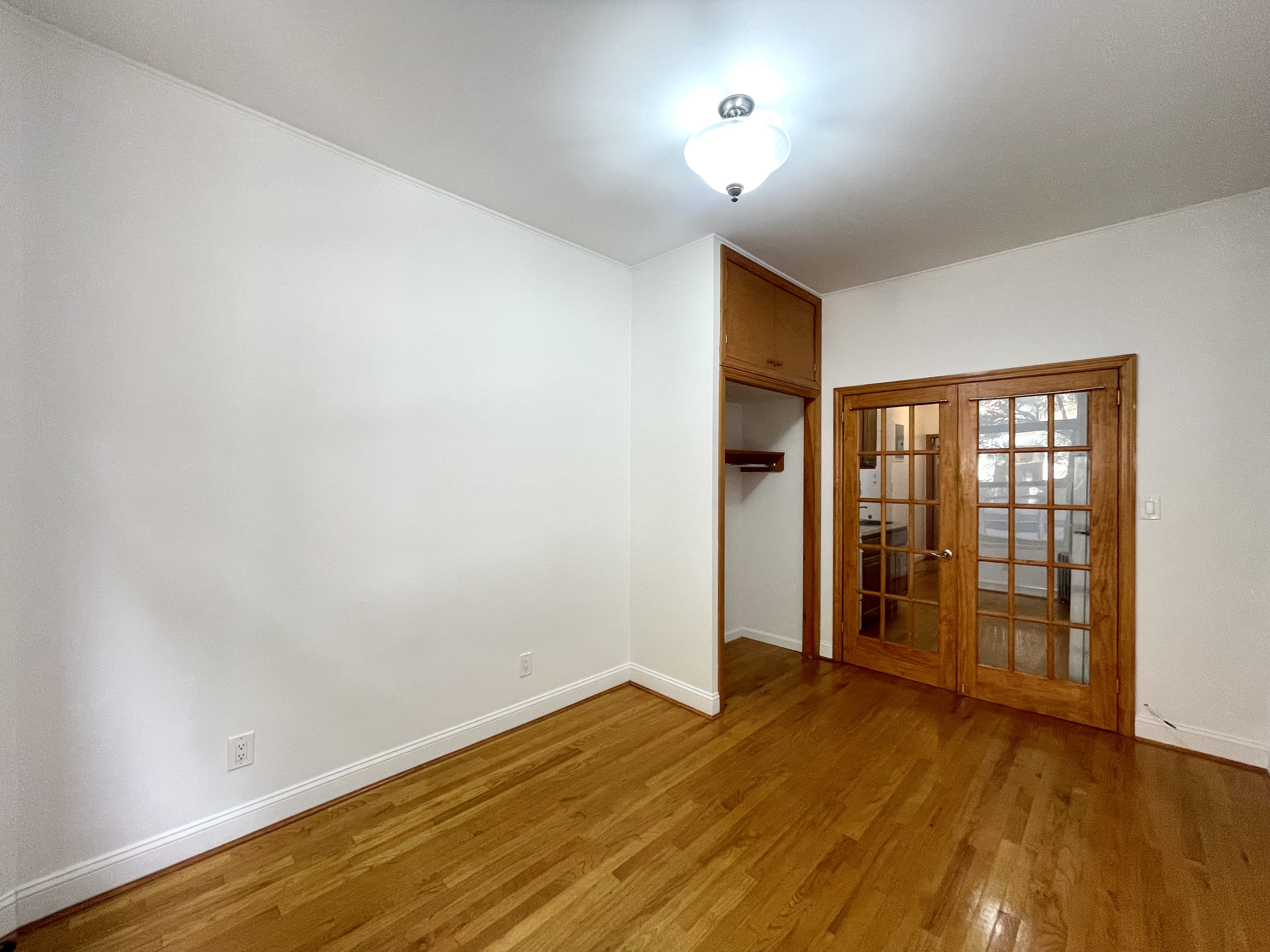 22 St Marks Place, Unit 19 Manhattan, NY 10003 - Photo 5 of 7 an empty room with wooden floor and windows