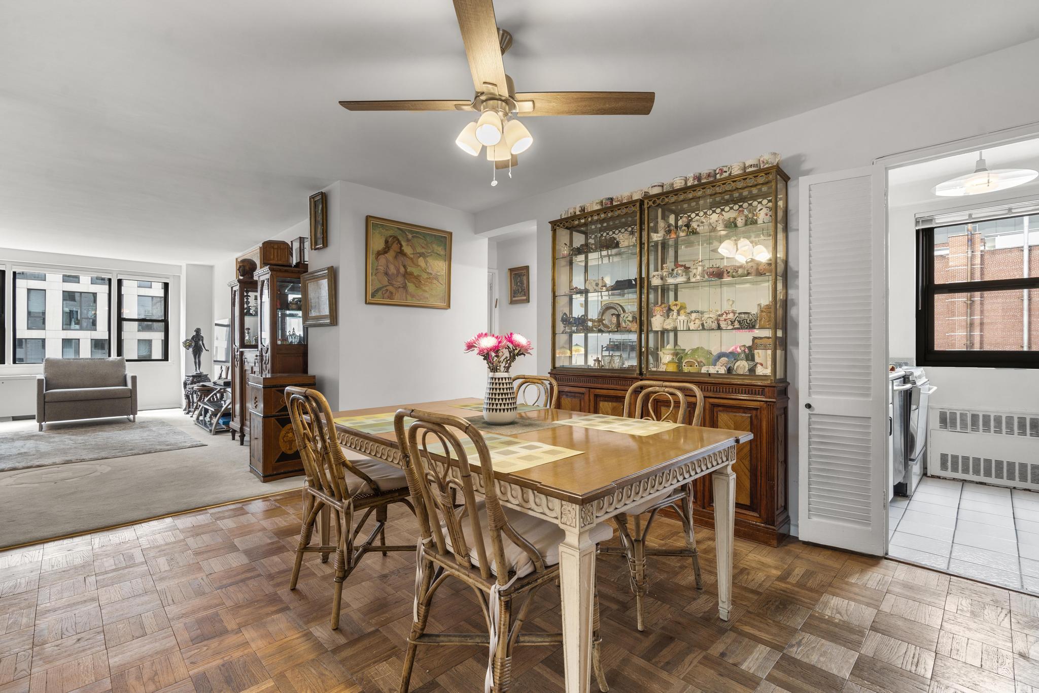 201 East 21st Street, Unit 8E Manhattan, NY 10010 - Photo 2 of 9 a dining room with furniture and window