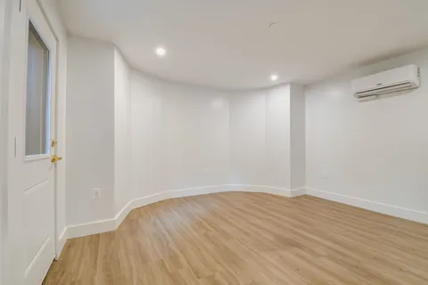 a view of room with wooden floor