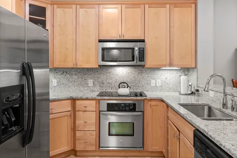 a kitchen with a sink stove and cabinets