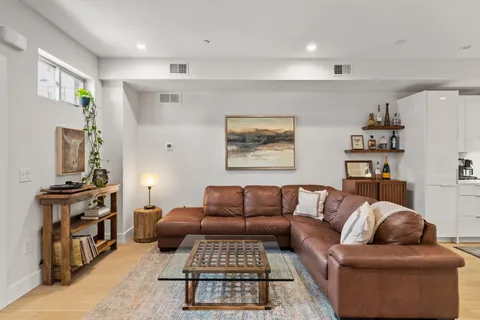 a living room with furniture ceiling fan and a rug