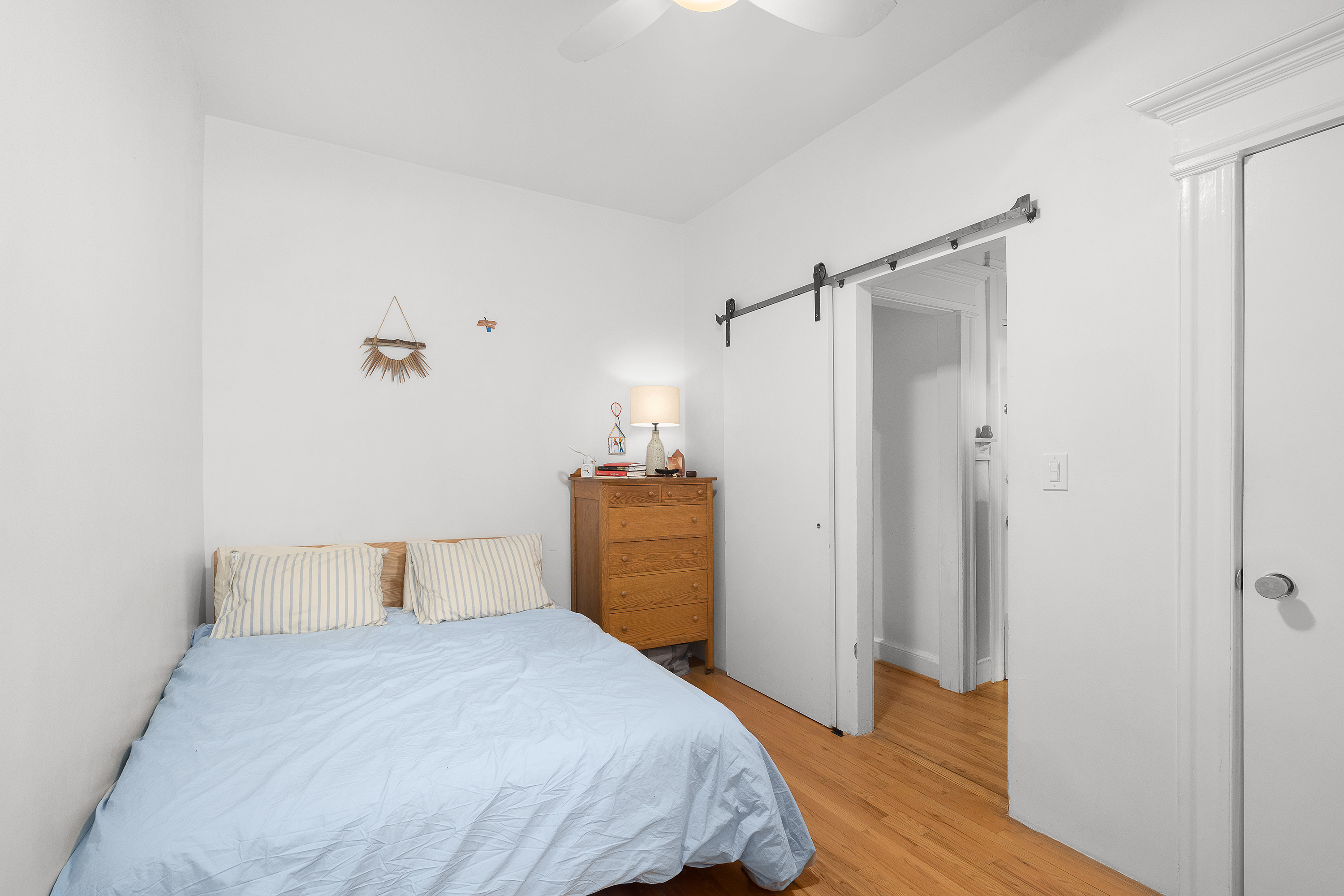 226 St James Place, Unit 1R Brooklyn, NY 11238 - Photo 8 of 14 a bedroom with a bed and wooden floor